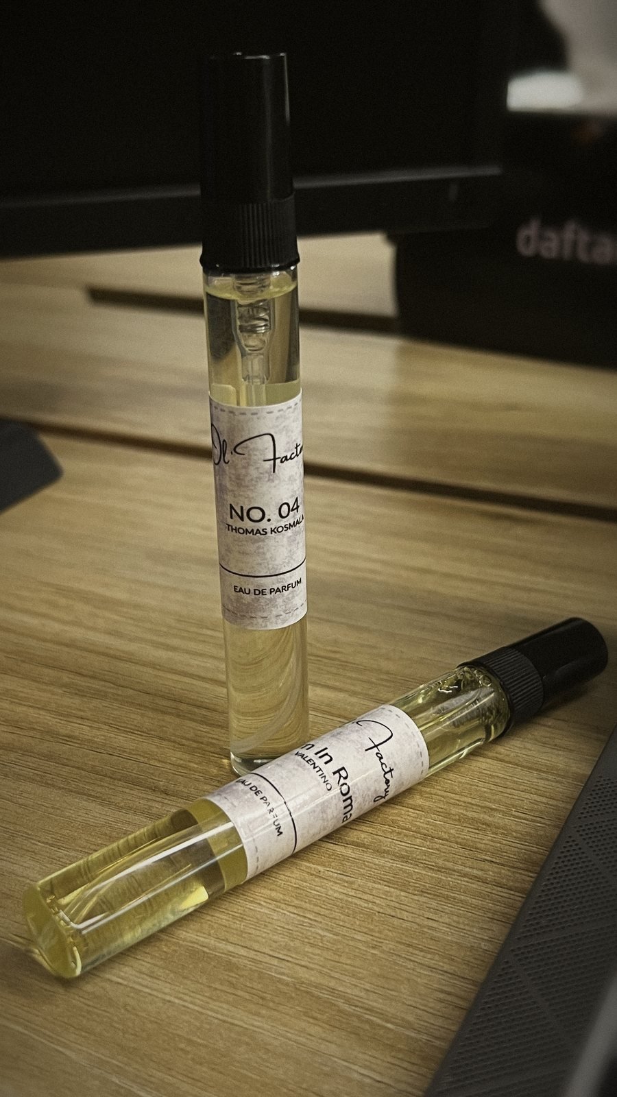 No. 04 and Born In Roma inspired perfume pens on a desk